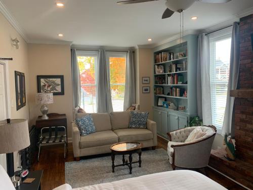 a living room with a couch and a chair at Seaway Manor B&B in Gananoque