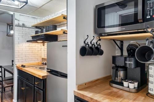 a kitchen with a sink and a microwave at Suite Serenity of Gatlinburg*indoor & outdoor pool in Gatlinburg