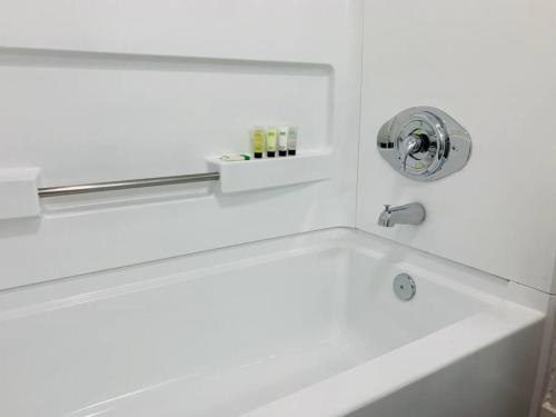 a white bath tub with a silver faucet at Universal Studios. Amazing 2 bedroom apartment! in Orlando