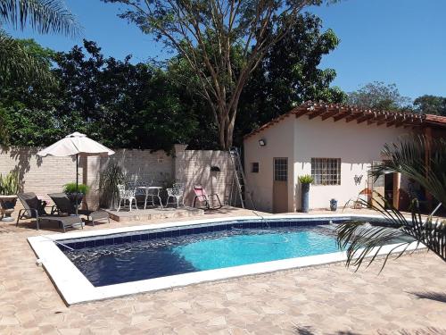 a swimming pool in front of a house at Casita-Azul in Ypacarai