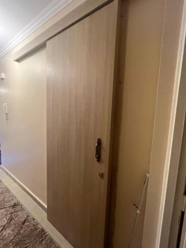 a door in a room with a wall at Luxurious VIP Apartment in Madinaty Furnished with High End Hotel Furniture in Madinaty