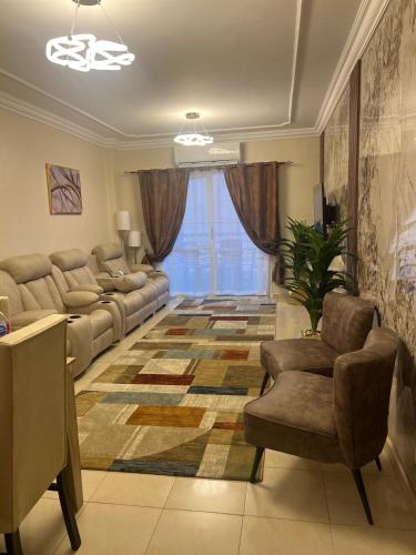 a living room with a couch and a chair at Luxurious VIP Apartment in Madinaty Furnished with High End Hotel Furniture in Madinaty