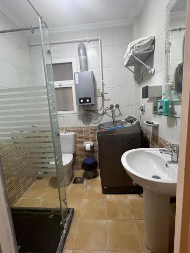 a bathroom with a shower and a toilet and a sink at Luxurious VIP Apartment in Madinaty Furnished with High End Hotel Furniture in Madinaty