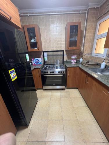 a small kitchen with a stove and a sink at Luxurious VIP Apartment in Madinaty Furnished with High End Hotel Furniture in Madinaty
