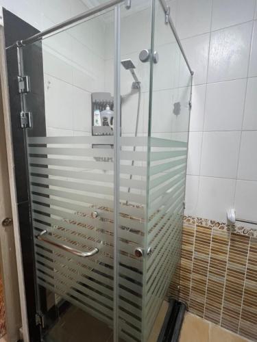 a shower with a glass door in a bathroom at Luxurious VIP Apartment in Madinaty Furnished with High End Hotel Furniture in Madinaty