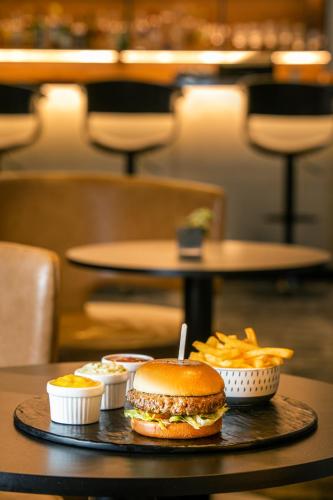 a tray with a hamburger and fries on a table at INNSiDE by Meliá São Paulo Iguatemi in Sao Paulo