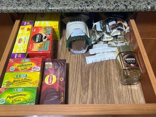 a drawer filled with food and other items on a counter at Luxurious VIP Apartment in Madinaty Furnished with High End Hotel Furniture in Madinaty