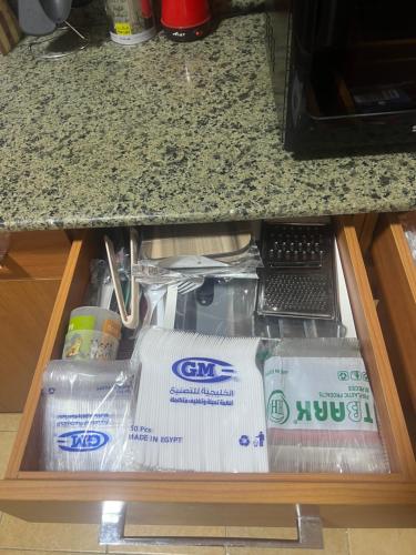 a drawer in a kitchen with some toiletries at Luxurious VIP Apartment in Madinaty Furnished with High End Hotel Furniture in Madinaty