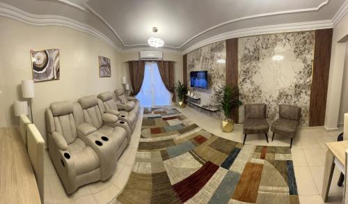 a salon with a waiting room with a couch and chairs at Luxurious VIP Apartment in Madinaty Furnished with High End Hotel Furniture in Madinaty