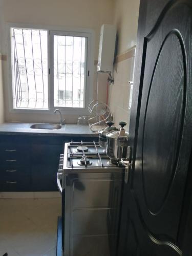 a kitchen with a stove and a stove top oven at Apartement bien équipé in Fez