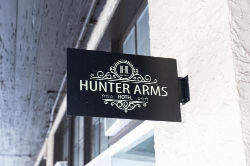 a sign for a hotel on the side of a building at Hunter Arms Hotel in Saint Cloud