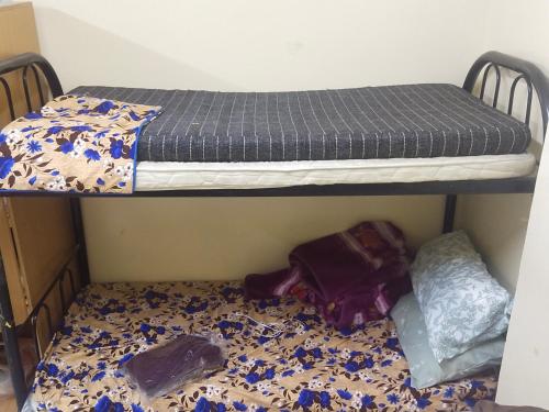 two bunk beds in a room with a bed at Bed space abu shagara park in Sharjah