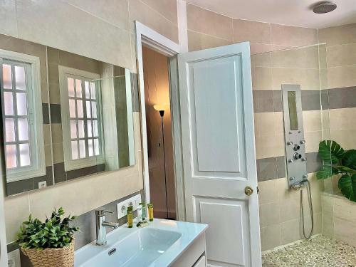 a bathroom with a sink and a mirror at Las Brisas 1 by SunHousescanarias in Las Palmas de Gran Canaria
