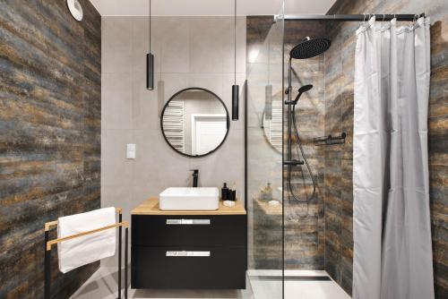 a bathroom with a sink and a shower at Spacious and modern Apartment Lwowska, close to Kazimierz in Kraków