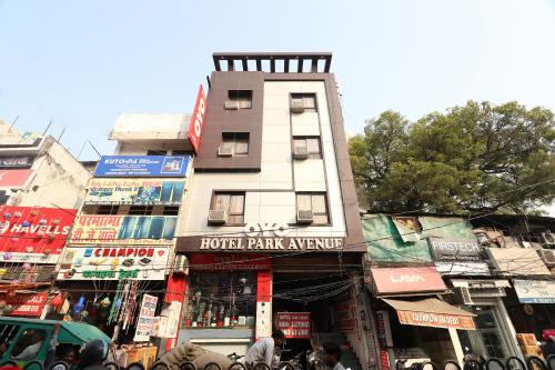 a tall building on a busy city street at Super OYO Flagship Hotel Park Avenue in Lucknow