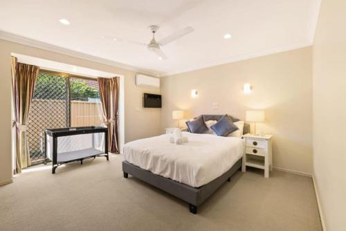 a large bedroom with a bed and a window at Decorated with love 4BD Family House with Pool in Brisbane