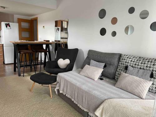 a living room with a bed and a table and a chair at Casa Calinka in Sant Jordi
