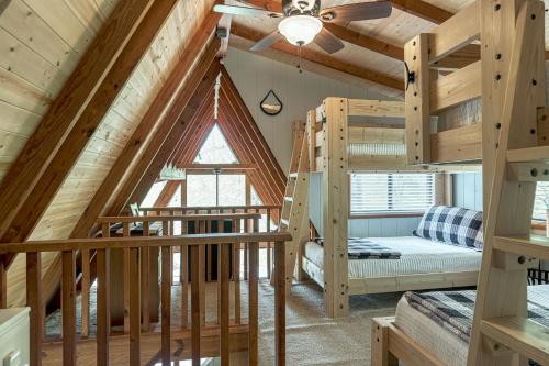 a loft bedroom with bunk beds in a log cabin at 1236 Hideaway Lake Chalet by Sarah Bernard Chalets with Private Dock and Hot Tub in Innsbrook