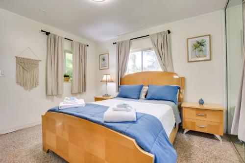 a bedroom with a large bed with blue pillows at Chic Deerfield Beach Cottage - Walk to Beach! in Deerfield Beach