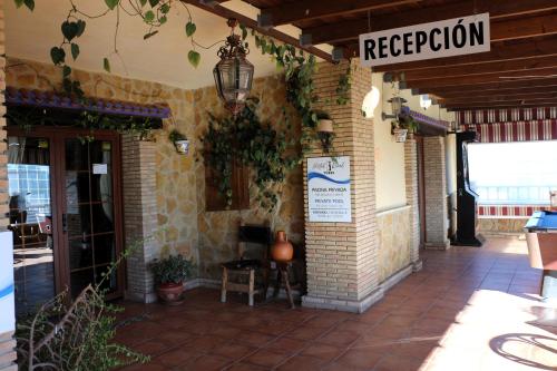 a restaurant with a sign on the side of a building at Hostal Rural Turre in Turre
