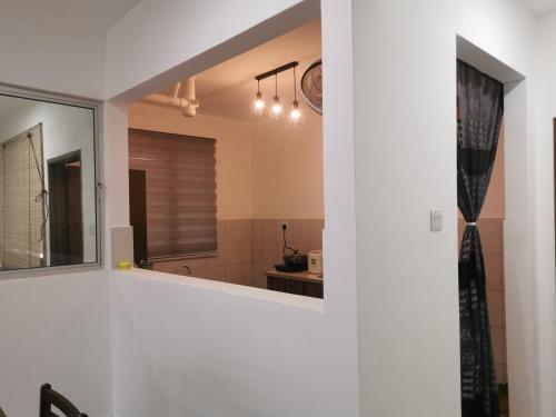 a bathroom with a mirror and a sink at Apartment Alor Gajah in Kampong Alor Gajah
