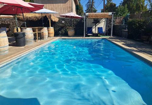 a swimming pool with blue water in a yard at Tropical Paradise in Fresno