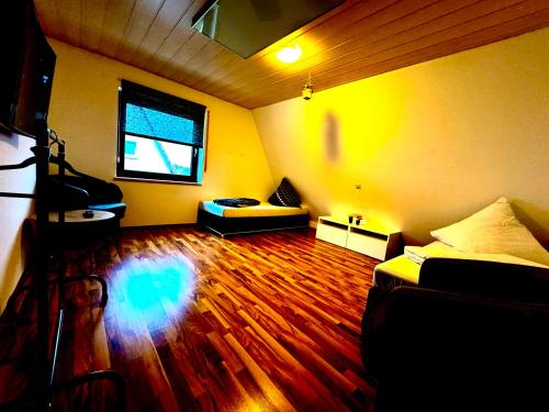 a room with a bed and a wooden floor at DreamHouse Apartments in Künzelsau