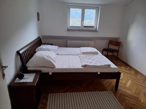 a bedroom with a large bed with a window at Apartment in Ossiach in Altossiach