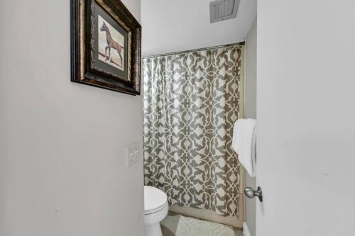 a bathroom with a toilet and a shower curtain at Mainsail 131 - Beachfront 2BR with Free Seasonal Beach Service in Destin