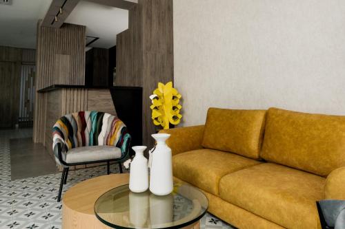 a living room with a couch and a table at Amari Living Suites in Barranquilla