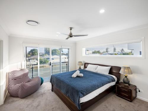 a bedroom with a bed and a zebra chair at 4BR Cozy house 5mins to beach in Gold Coast