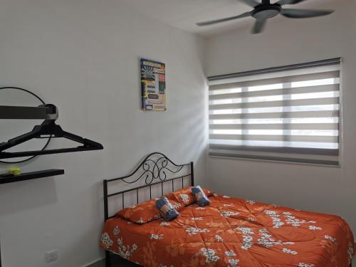 a bedroom with a bed and a ceiling fan at Apartment Alor Gajah in Kampong Alor Gajah