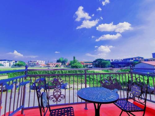 a patio with a table and chairs on a balcony at Ipoh town centre glamping home 13pax in Ipoh