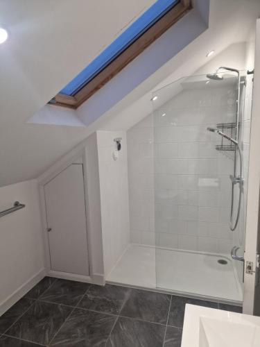 a bathroom with a shower with a glass shower backdoor at Confystay in London