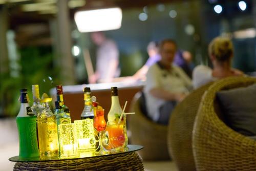 a tray of bottles and glasses on a table at The Haven Khao Lak in Khao Lak