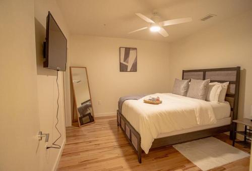 een slaapkamer met een bed en een flatscreen-tv bij Urban Oasis in Overton Square in Memphis