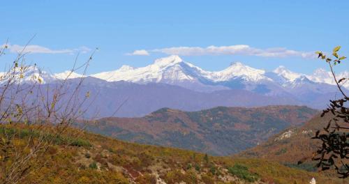 a view of a mountain range with snow capped mountains at Racha Nanida in Agara
