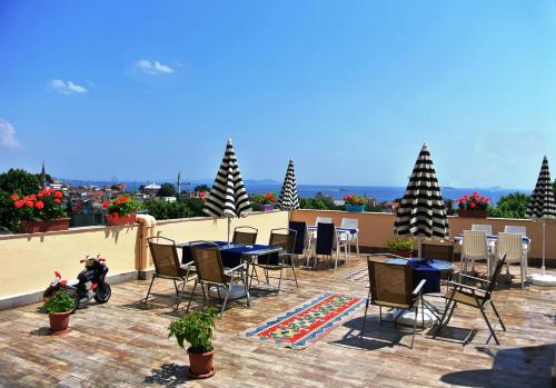 a patio with tables and chairs on a roof at Fors Hotel in Istanbul