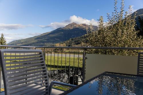 a balcony with a bench and a view of a mountain at Appartement Monika in Neukirchen am Großvenediger