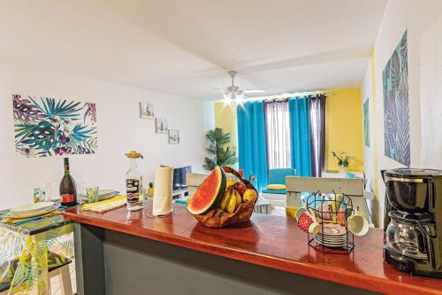 a kitchen with a counter with a bowl of fruit on it at Gwad'AZUR - séjour tout confort en Guadeloupe in Le Gosier