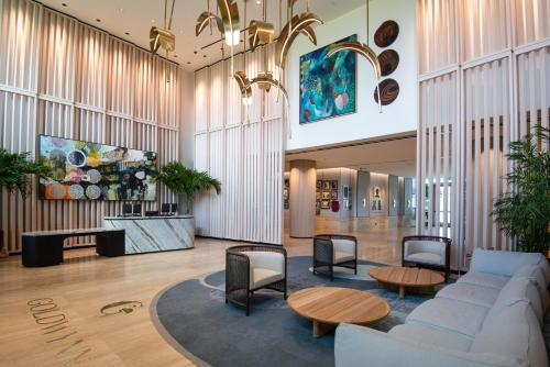 a lobby with a couch and a table and chairs at Goldwynn Resort & Residences in Nassau