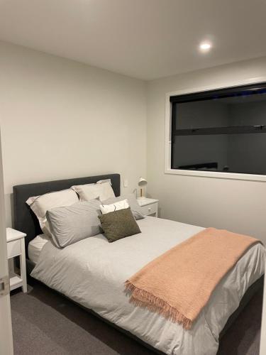 a bedroom with a large bed with a window at Beckford House in Methven