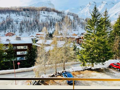 a view of a resort with snow covered trees and mountains at Eden Studio La foux d Allos centre station , 50 m du centre avec terrasse plein sud , chambre 4 couchages in La Foux