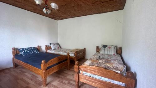 a bedroom with two beds in a room at Guest House BOZVILL in Bozovec