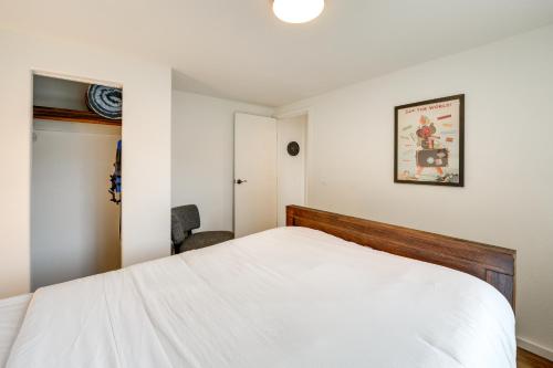 a bedroom with a white bed and a chair at Lakefront Mount Vernon Home with Private Dock! in Mount Vernon