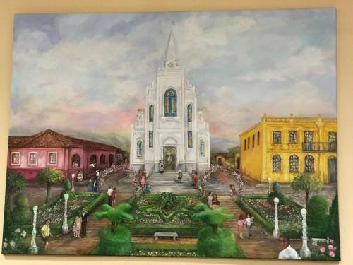 a painting of a white building with a garden at Hotel Villa de Minas in Monte Sião