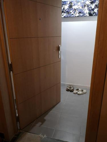 a hallway with a pair of shoes next to a door at Appart VH - Bienvenue au Lilas in Les Lilas