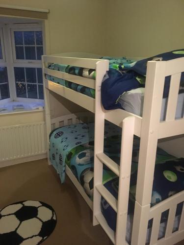 a white bunk bed in a room with at Lovely Two bed flat located in the heart of Dunstable in Dunstable