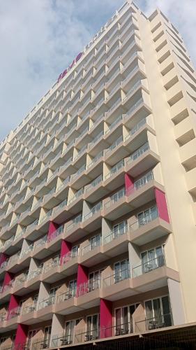 a large apartment building with pink balconies at Mariot in Pulauberayan
