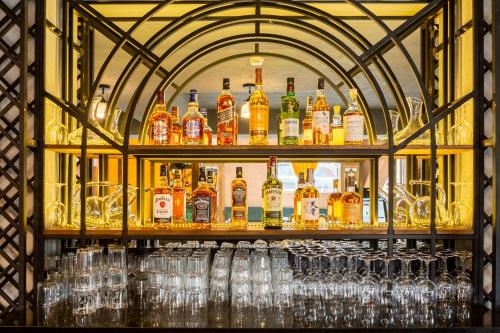 a bar with glasses and bottles of alcohol on display at Biography Design Tbilisi in Tbilisi City